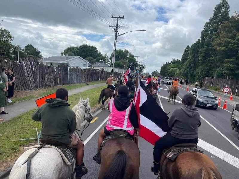 Horse riders, carrying a Tino Rangatiratanga flag at Tūrangawaewae Marae