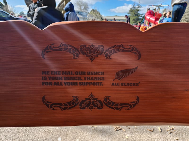 The inscription on the All Black bench.