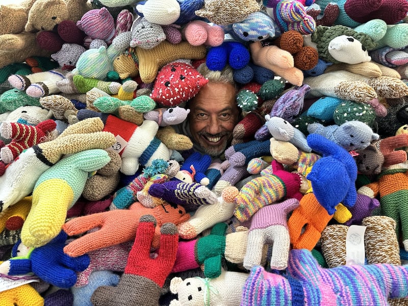 Mike King in a sea of donated knitted huggy bears.