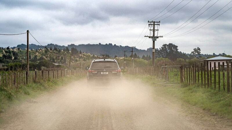 A car on Kawekawe Rd in Rūātoki throws up dust at the five homes and urupā located next to the road.